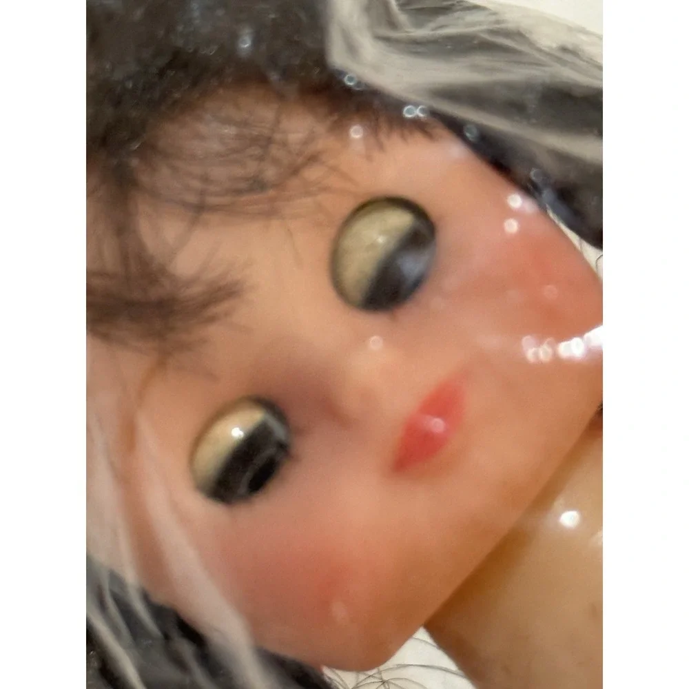 vintage 8-inch doll from Frank's with movable eyes, braids, and white panties.